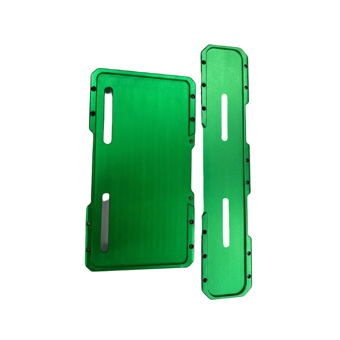 Two bright green anodized metal parts with cutouts, shown on a bubble wrap background.