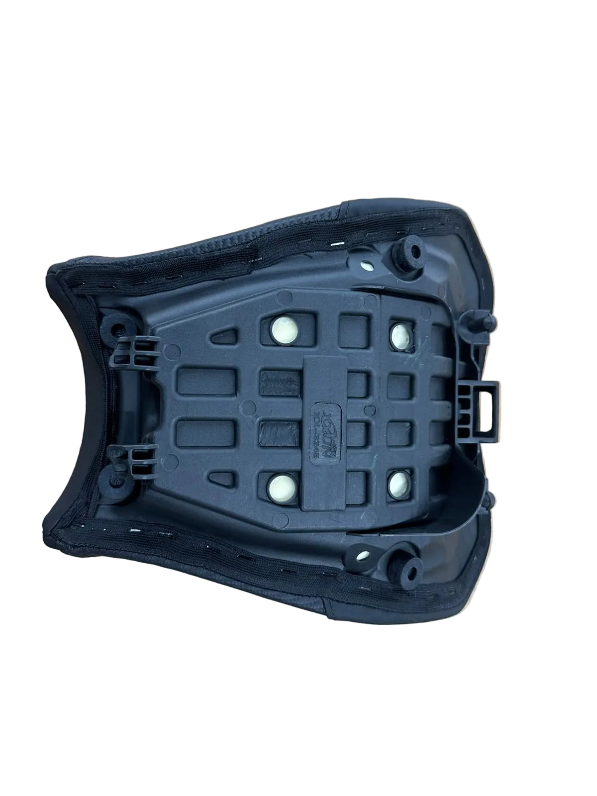 A black molded plastic automotive seat cushion or seat shell component, photographed from above on a light wood-grained surface.