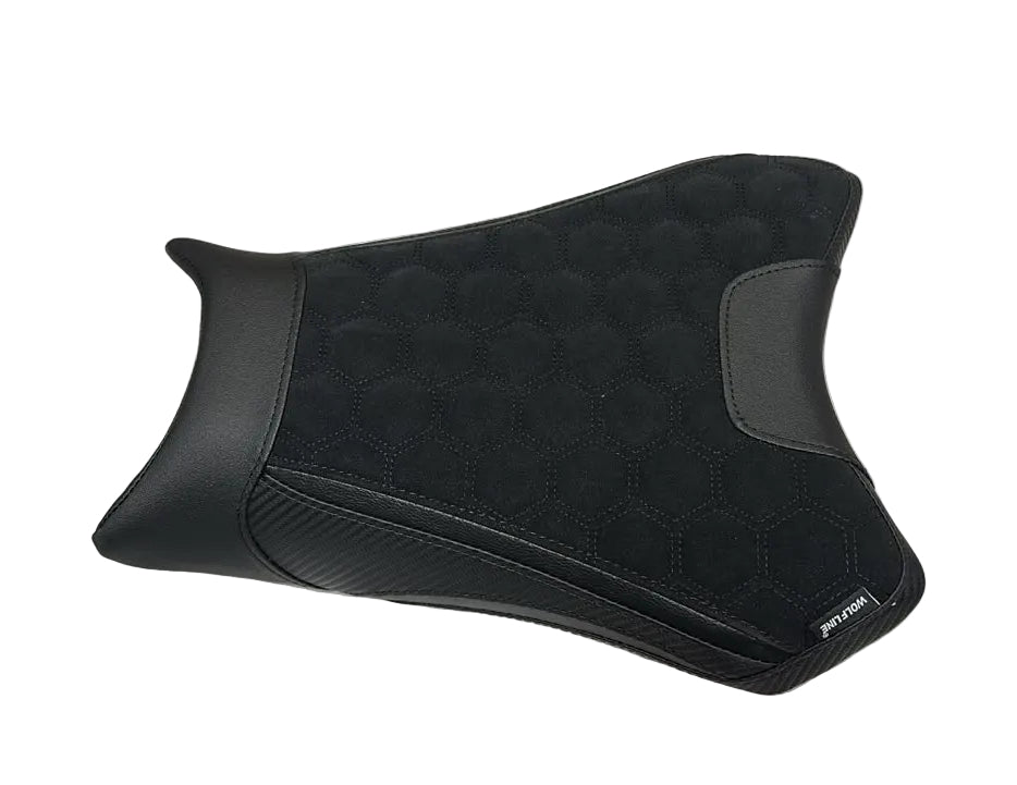 A black motorcycle or scooter seat cover or cushion with a quilted diamond pattern and textured side panels, placed on a white sheet of paper.