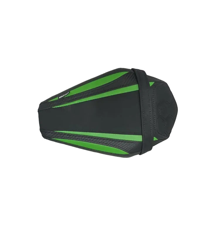 A black motorcycle or scooter seat cover with bright green accents, displayed on a white sheet over cardboard boxes.