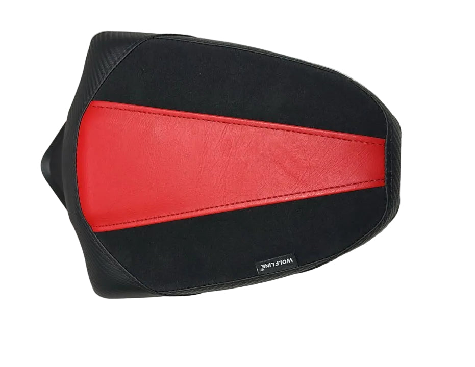 A motorcycle or scooter seat pad cover featuring a black body with a prominent red center stripe, resting on a white textured surface.