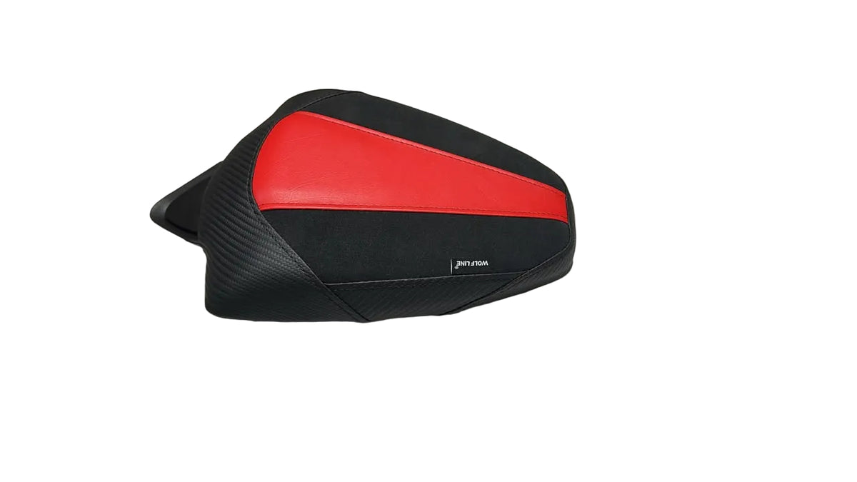 A motorcycle or scooter rear-view mirror cover with a black and red design, placed on a white plastic sheet with cardboard boxes in the background.