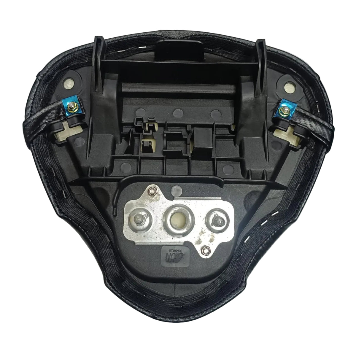 Black motorcycle or scooter seat underside with visible mounting hardware, plastic inserts, and two small blue terminal covers on a light gray fabric background.