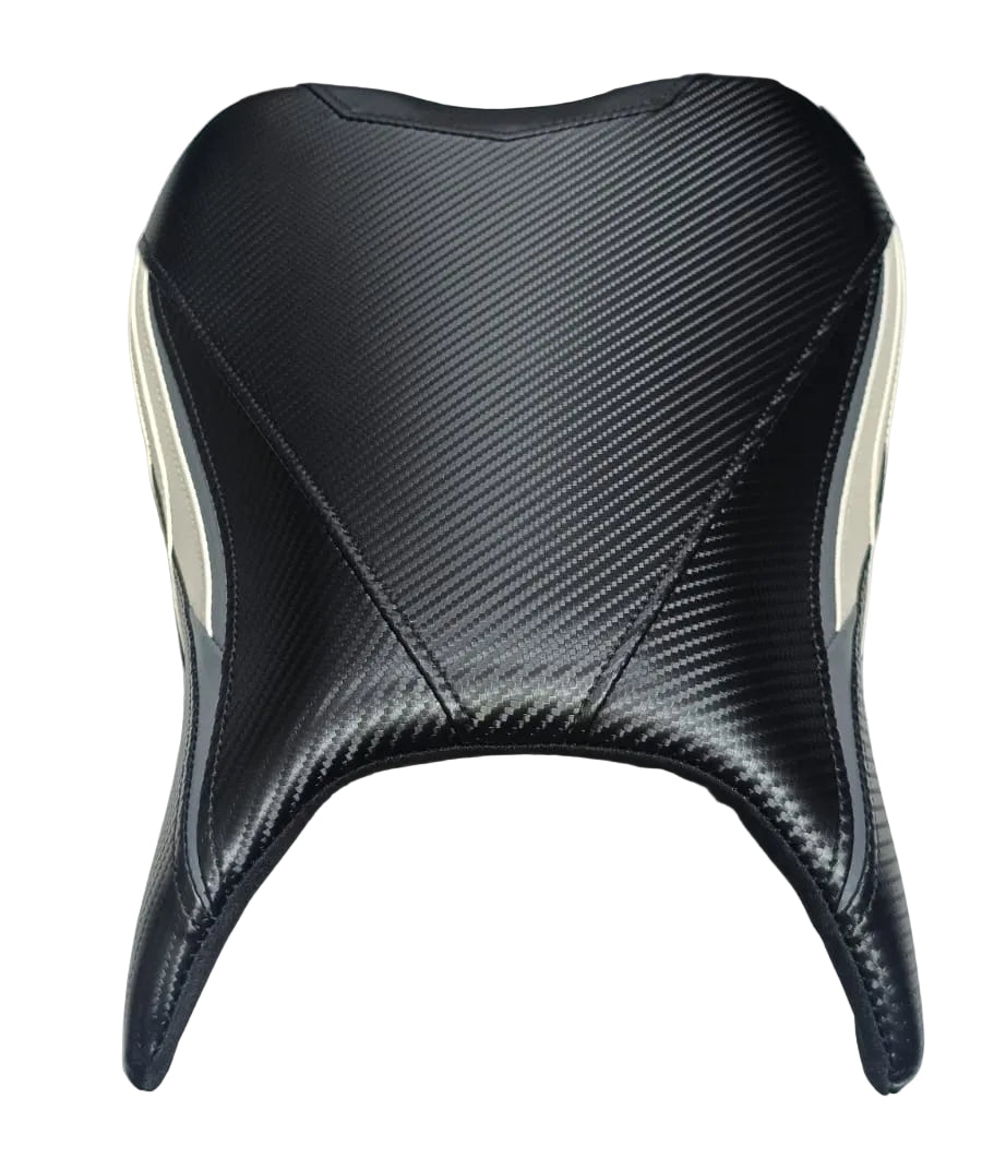 A black carbon-fiber-pattern motorcycle or scooter seat cover with cream-colored side panels, displayed on a white cloth.
