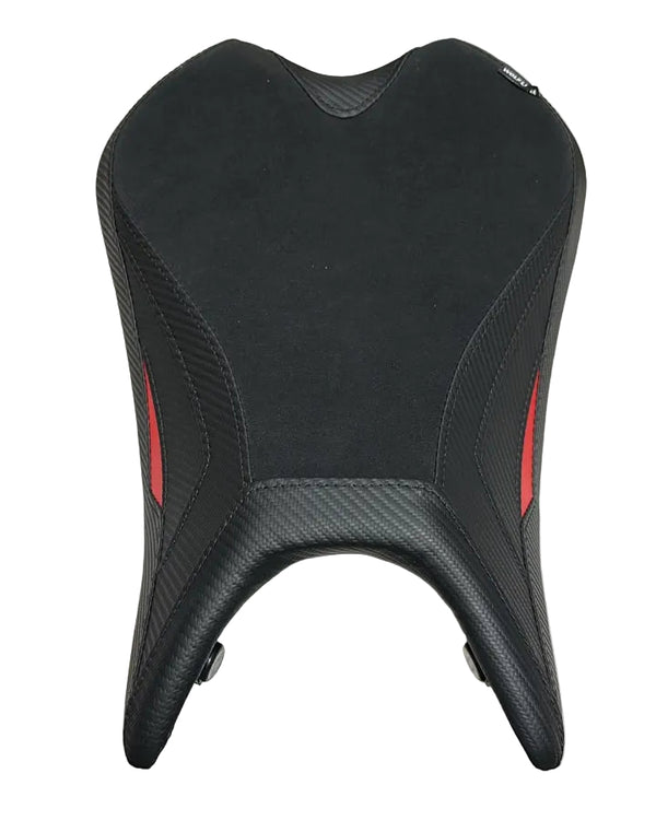 A black motorcycle or scooter seat cover with textured carbon-fiber-style side panels and small red accent stripes, laid flat on a white sheet.