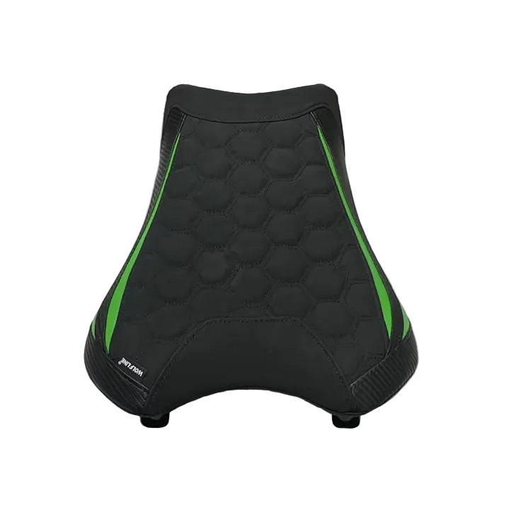 A motorcycle or bicycle seat cover in black with bright green side accents, laid flat on a white sheet inside a warehouse or storage area.