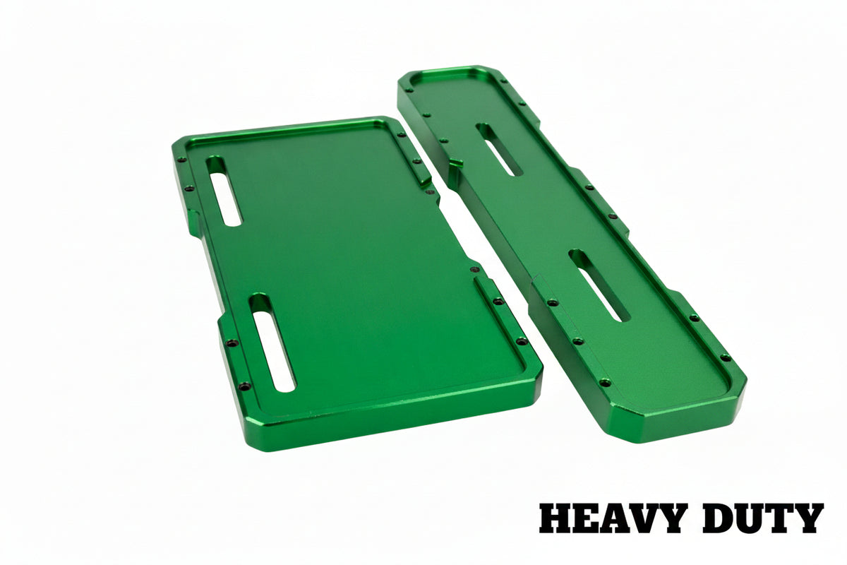 Two bright green anodized metal parts, likely CNC-machined brackets or plates, displayed on a bubble wrap background.