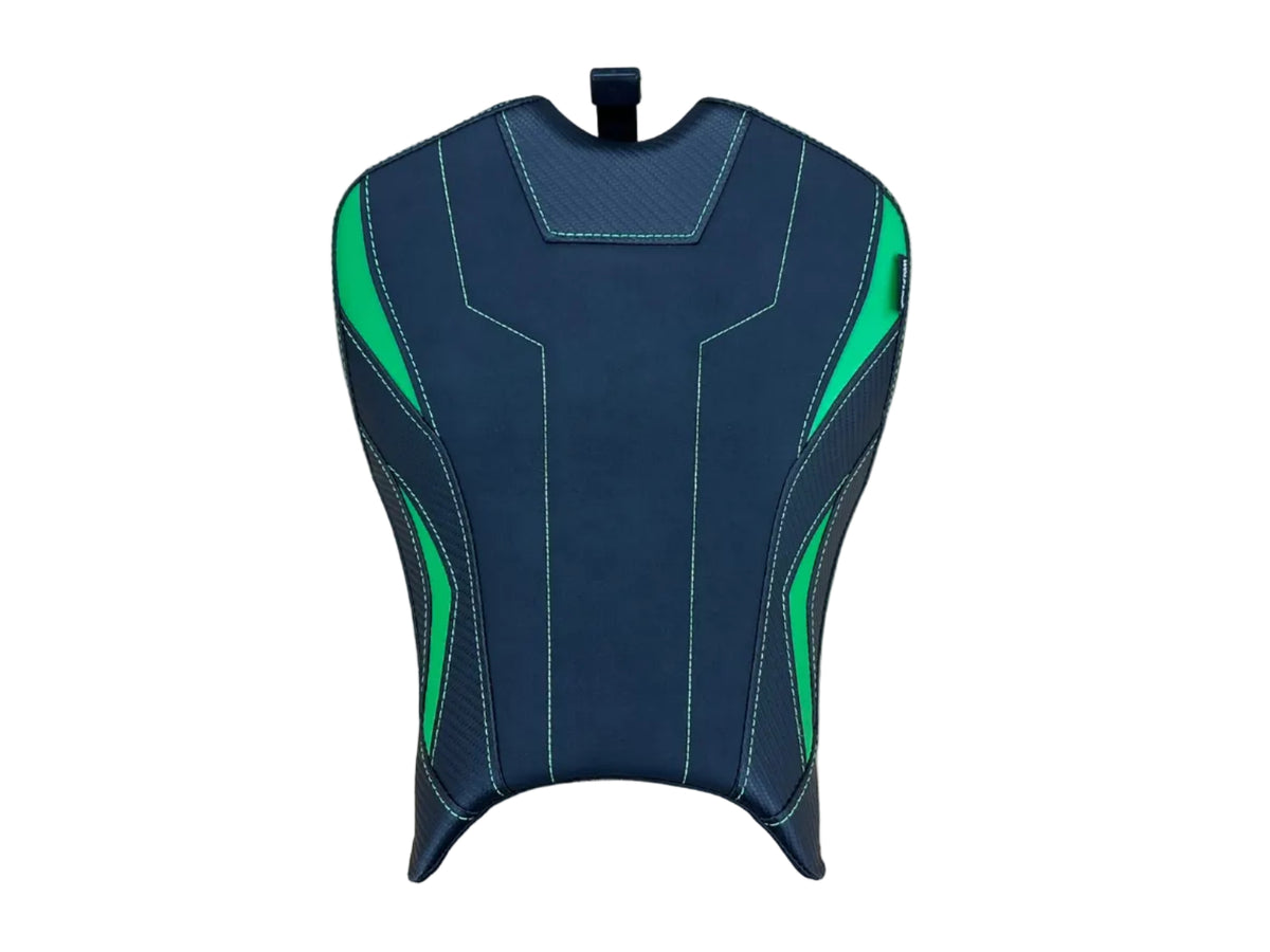 A motorcycle or scooter seat cover with a black and dark gray design accented by bright green stitching and graphic details, shown on a light wood tabletop.