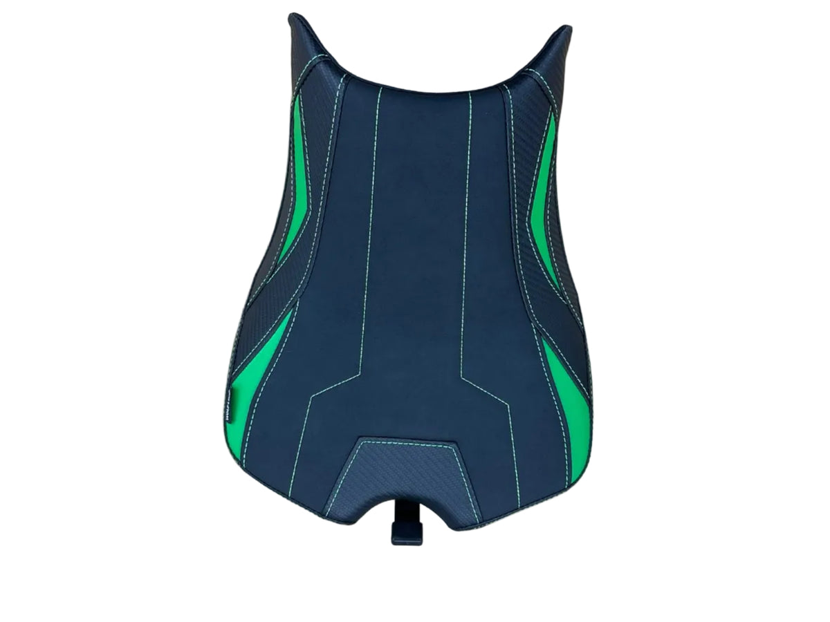 A motorcycle or scooter seat cover with a black and dark gray design, accented by bright green graphics and white contrast stitching, shown on a light wood tabletop.